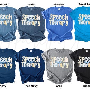 May include: A collection of t-shirts in various colors, including blue jean, denim, flo blue, royal caribe, navy, true navy, grey, and black. Each shirt features the words "Speech Therapy" in a decorative font.
