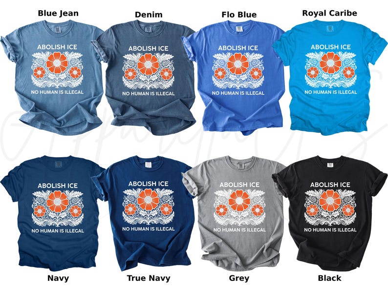May include: A collection of t-shirts in various colors, including blue, navy, gray, and black. Each shirt features the text "ABOLISH ICE" above a floral design with orange flowers and the text "NO HUMAN IS ILLEGAL" below.