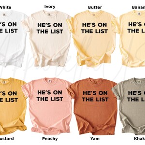 May include: Eight t-shirts in a range of colours: white, ivory, butter, banana, mustard, peachy, yam, and khaki. Each shirt has the text "HE'S ON THE LIST" printed in bold black lettering.