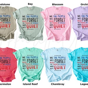 May include: A collection of eight short-sleeved t-shirts in various colors, each displaying the message "WE THE PEOPLE WILL NEVER FORGET THE COWARDS IN CONGRESS WHO KEPT QUIET" in a bold, patriotic design. Colors include tan, blue, pink, purple, red, teal, light blue, and turquoise.