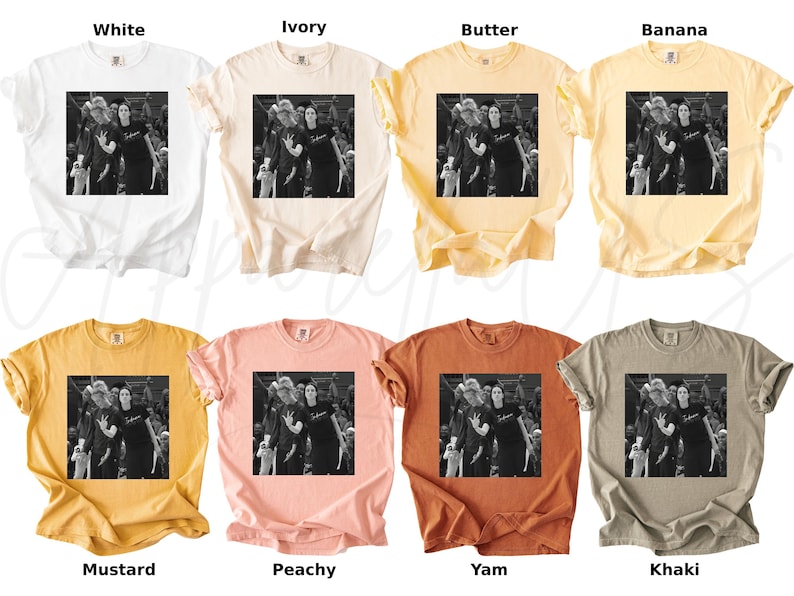 May include: A collection of eight t-shirts in various colors, including white, ivory, butter, banana, mustard, peachy, yam, and khaki. Each shirt features a black and white image of a group of people. The shirts are short-sleeved.