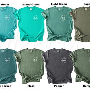 May include: Ten different color t-shirts with the text "Cool Aunts Club" printed on the front. The t-shirts are in the colors seafoam, island green, light green, sage, blue spruce, moss, pepper, and hemp.