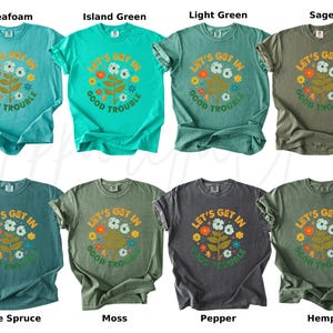 Peut inclure: Collection de huit t-shirts de couleurs vari&eacute;es, dont vert d'eau, vert &icirc;le, vert clair et sauge. Chaque t-shirt arbore un motif floral et le texte "LET'S GET IN GOOD TROUBLE".