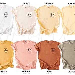 May include: Ten different color t-shirts with the text "Cool Aunts Club" printed on the front. The colors are white, ivory, butter, banana, mustard, peachy, yam, khaki, and two shades of grey.