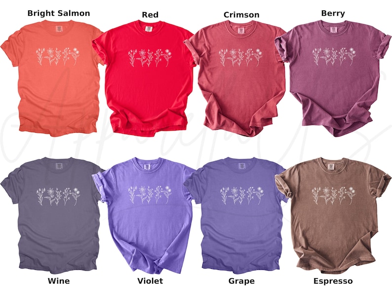 May include: Ten t-shirts in a variety of colours, including bright salmon, red, crimson, berry, wine, violet, grape, and espresso. Each shirt features a simple white floral design.