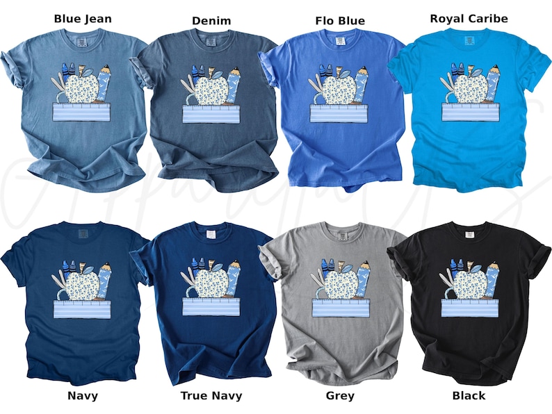 May include: A set of ten t-shirts featuring a graphic of a blue apple with school supplies, including pencils, crayons, scissors, and a ruler. The t-shirts are available in ten different colors: blue jean, denim, flo blue, royal caribe, navy, true navy, grey, black, white, and pink.