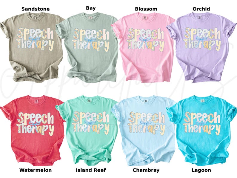 May include: A collection of eight t-shirts in various colors, including tan, green, pink, purple, red, teal, light blue, and turquoise. Each shirt displays the words "Speech Therapy" in a decorative font.
