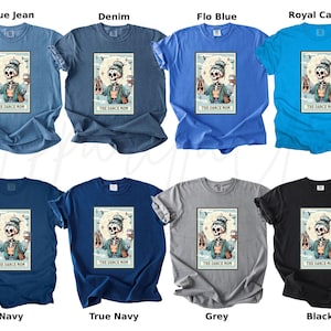 May include: A collection of t-shirts in various colors, including blue, navy, grey, and black. Each shirt features a graphic of a skeleton with ballet shoes and a coffee cup, with the text "THE DANCE MOM".