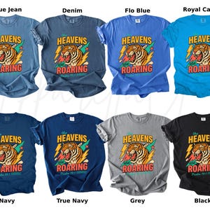 May include: A collection of t-shirts in various colors, including blue, navy, grey, and black. Each shirt features a graphic of a roaring tiger with the text "HEAVENS are ROARING" and "Psalm 19:1".