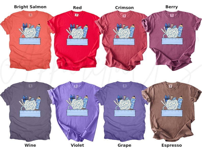 May include: A set of ten t-shirts featuring a colorful illustration of a patterned apple with school supplies. The shirts are available in ten different colors: bright salmon, red, crimson, berry, wine, violet, grape, espresso, teal, and navy.