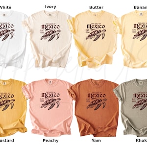 May include: Ten different color t-shirts with a graphic print of a sea turtle and the text "The Gulf of Mexico Est. 1900". The colors are white, ivory, butter, banana, mustard, peachy, yam, khaki.