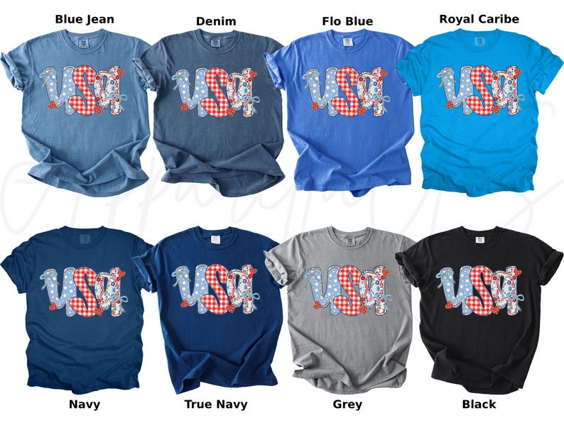 May include: A collection of eight t-shirts in various colors, including blue, navy, grey, and black. Each shirt features the word "USA" in a patriotic design with red, white, and blue elements. The shirts are short-sleeved.