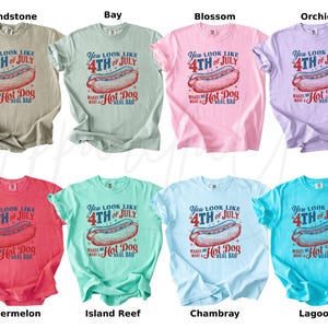 May include: A collection of eight t-shirts in various colors, each featuring a graphic of a hot dog and the text "You look like 4th of July makes me want a hot dog real bad." Colors include sandstone, bay, blossom, orchid, watermelon, island reef, chambray, and lagoon.