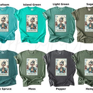 May include: A collection of eight t-shirts in various colors, including seafoam, island green, and sage. Each shirt features a graphic of a skeleton holding ballet shoes and a coffee cup, with the text "THE DANCE MOM".