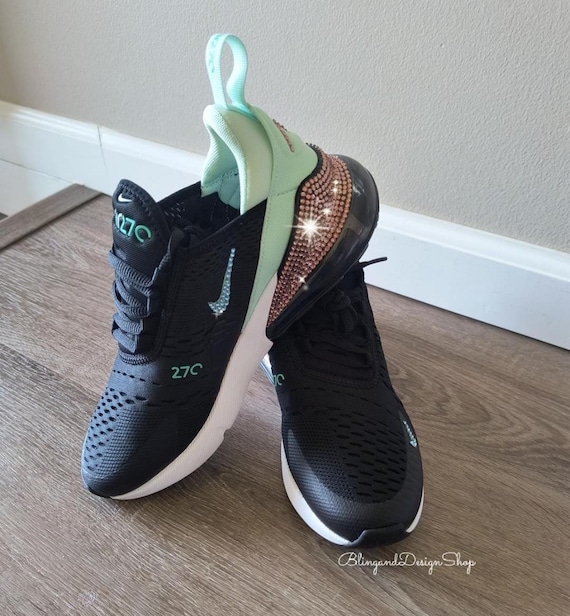 black nike shoes with teal swoosh