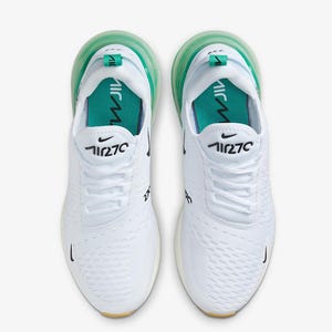 May include: Pair of white athletic shoes with green accents. The shoes feature the number "270" in black on the side and tongue, with a green air bubble sole. The Nike swoosh logo is visible.