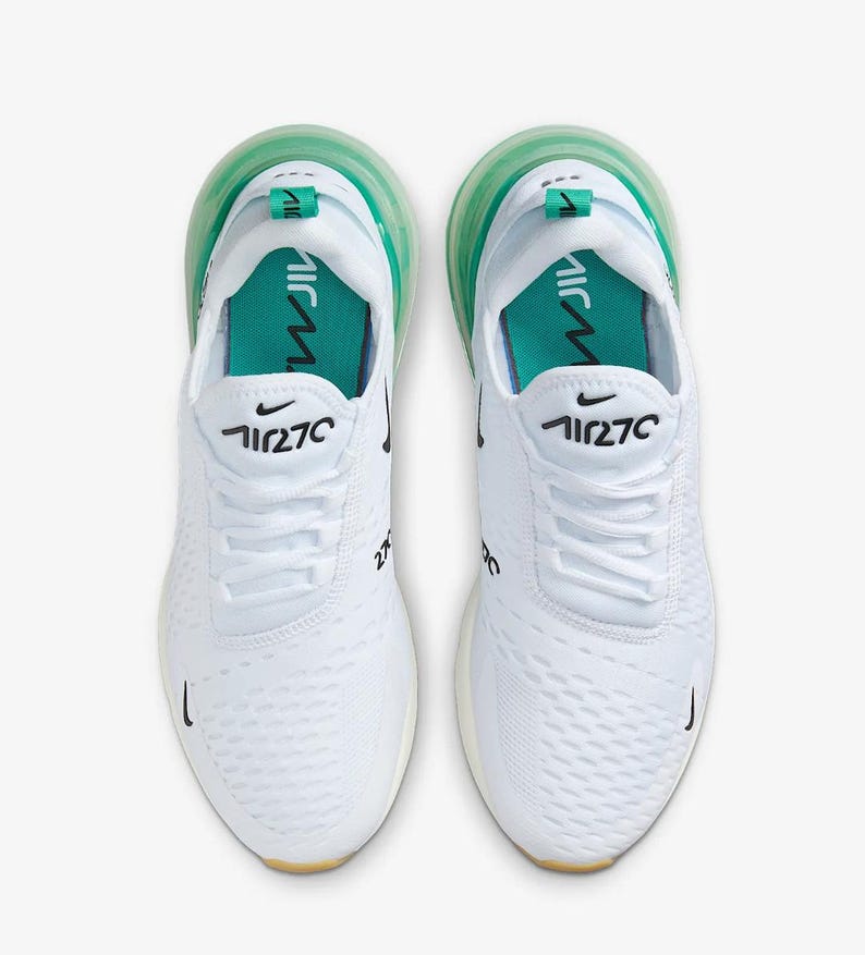 May include: Pair of white athletic shoes with green accents. The shoes feature the number "270" in black on the side and tongue, with a green air bubble sole. The Nike swoosh logo is visible.