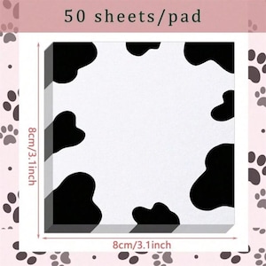 May include: A pad of 50 sheets of white paper with a black and white cow print design. The pad measures 8 cm by 8 cm.