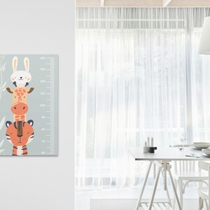 May include: A colourful growth chart featuring a giraffe, a rabbit, and a tiger stacked on top of each other. The chart has a light blue background with white bamboo stalks and a white measurement scale in centimetres.
