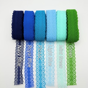 May include: A collection of lace ribbons in various shades of blue and green. The colors include navy blue, royal blue, picooc, light blue, mint green, and green. Each ribbon is labeled with its respective color name.