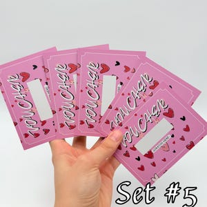 May include: Set of five pink scratch-off cards with the text "You Cash" and hearts. The cards have a silver scratch-off area and the text "Scratch Here". The cards are held in a hand. The text "Set #5" is at the bottom of the image.