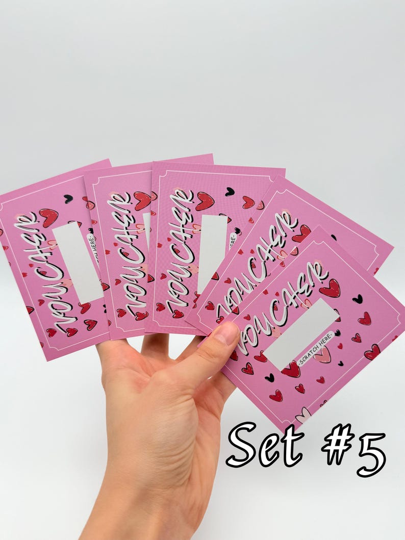 May include: Set of five pink scratch-off cards with the text "You Cash" and hearts. The cards have a silver scratch-off area and the text "Scratch Here". The cards are held in a hand. The text "Set #5" is at the bottom of the image.