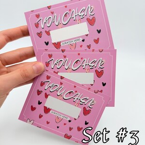 May include: Set of three pink scratch-off vouchers with a heart pattern and the word "VOUCHER" written in white. The text "SCRATCH HERE" is printed on each voucher. The text "Set #3" is printed below the vouchers.