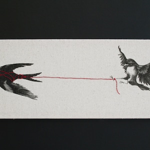 May include: Two black birds are connected by a thin red string. The bird on the left is tied to the string, while the bird on the right is pulling on the string.
