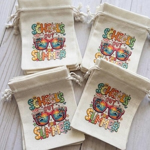 May include: A collection of small, off-white drawstring bags. Each bag features a colorful graphic with the text "SCHOOL'S OUT FOR SUMMER" and sunglasses with a beach scene. The bags are made of a natural fabric.