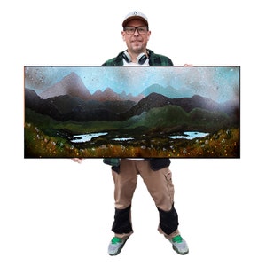 May include: A landscape painting featuring a mountain range with a lake and a sky with a gradient of blue and gray. The artwork is framed in a black rectangular frame. The painting has a dark green and brown color palette.