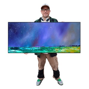 May include: An abstract landscape painting with a starry night sky in shades of blue, purple, and white. The foreground features a turquoise and green body of water and a green and yellow land mass. The painting is in a black frame.