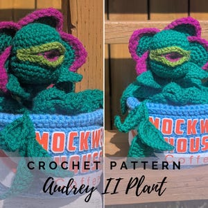 May include: A crocheted Audrey II plant from Little Shop of Horrors, featuring a green head with a pink and green flower, and green leaves. The plant is in a blue coffee cup with the words "MOCKW HOUSE" and "coffee" on it. The text "CROCHET PATTERN Audrey II Plant" is also visible.