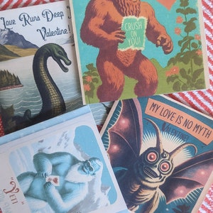 May include: Four vintage Valentine's Day cards featuring illustrations of a monster, a yeti, a creature from the black lagoon, and a dinosaur. The cards have a light blue, light green, and light brown background with red, white, and black text.