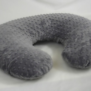 May include: A gray U-shaped pregnancy pillow with a textured fabric cover.
