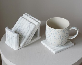 Marble holder with 4 square coasters featuring a unique marble effect. A modern, minimalist accent for stylish home decor