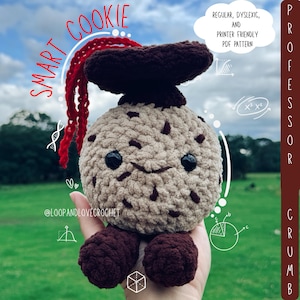 May include: A crocheted Smart Cookie plushie with a brown mushroom cap and feet, and a red tassel. The cookie has a smiling face and is tan with brown chocolate chip details. Text on the image says "Regular, Dyslexic, and Printer Friendly PDF Pattern."