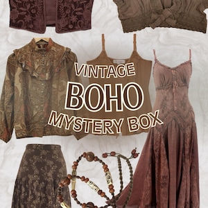 May include: A collection of vintage boho clothing and accessories in shades of brown. Items include a vest, blouses, a skirt, a dress, and necklaces. The text "VINTAGE BOHO MYSTERY BOX" is displayed in the center of the image.