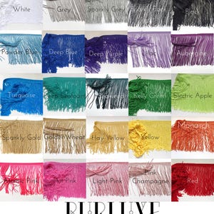 May include: A collection of 20 different colours of fringe trim, each colour is displayed in a separate square. The colours include white, grey, sparkly grey, black, powder blue, deep blue, deep purple, lilac, aubergine, turquoise, deep seafoam, seaweed, kelly green, electric apple, sparkly gold, golden wheat, hay yellow, yellow, monarch, atomic pink, hot pink, light pink, pink champagne, and red. The trim is made of a soft, silky material and is perfect for adding a touch of glamour to any project.