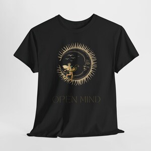 May include: Black t-shirt with a gold sun and crescent moon design featuring a fairy with wings. The text "OPEN MIND" is printed below the design.