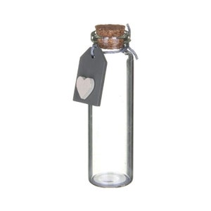 May include: A clear glass bottle with a cork stopper and a grey tag with a white heart attached. The bottle is rectangular and empty. The cork is secured with twine. The bottle is approximately 10 cm tall.