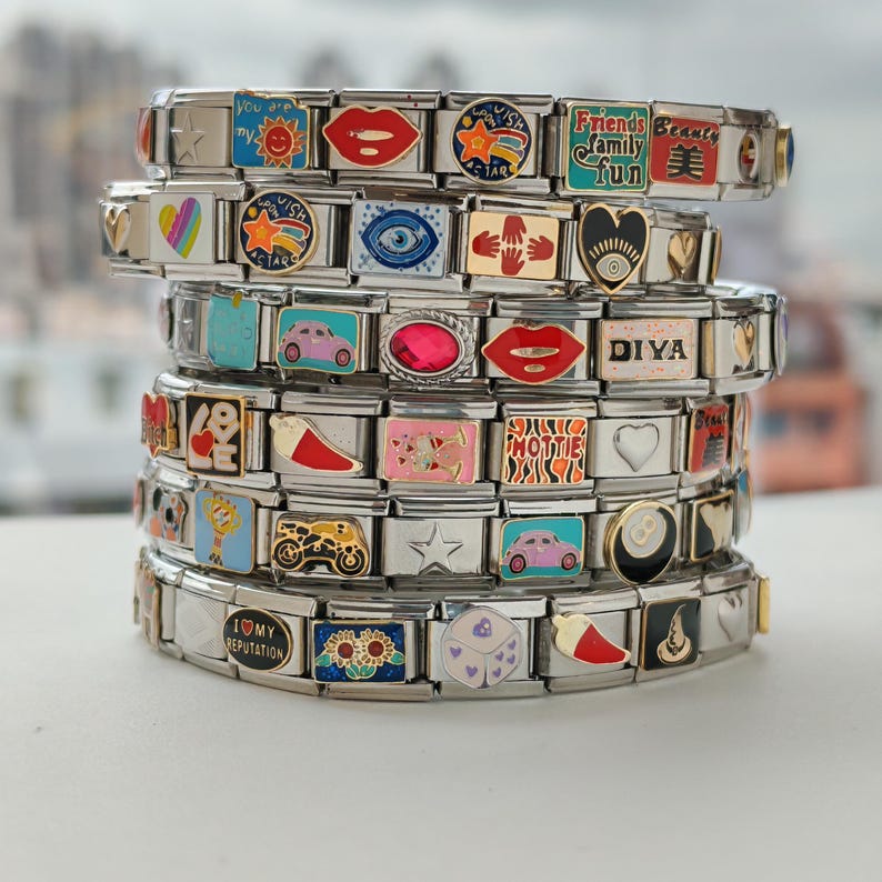 a stack of metal bracelets with different designs on them