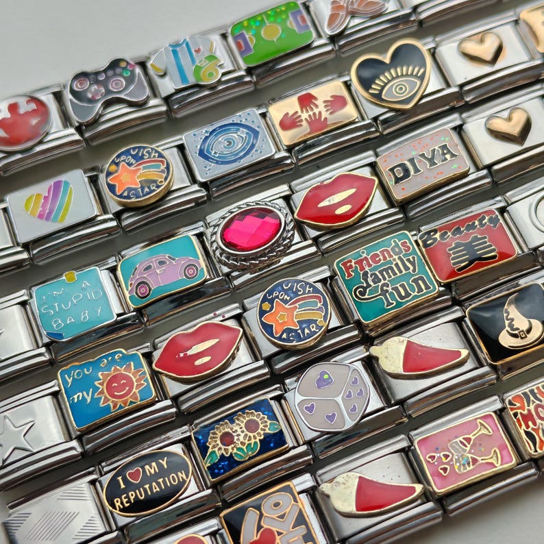 A striking silver Italian charm bracelet with bold, modular links and customizable charms. Designed to make a statement, this bracelet combines sleek silver with personal flair, perfect for adding edge to any outfit.