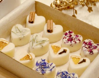 May include: A cardboard box containing heart-shaped wax melts decorated with dried orange slices, cinnamon sticks, cloves, and flower petals. The text "Christmas Bundle: Botanical" is printed in the bottom left corner of the image.