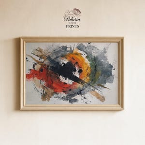 May include: Abstract art print in a light wood frame. The artwork features a circular design with splashes of black, orange, red, and gray paint. The text "Palaria Store Prints" is at the top.