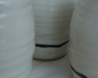 a Set of Four Cups, or Tumblers, in white with a black stripe