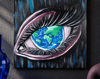 May include: A square canvas painting featuring a large, detailed human eye with long, dark eyelashes. The iris of the eye is replaced by a vibrant, circular depiction of the Earth, showing blue oceans and green landmasses against a dark background.