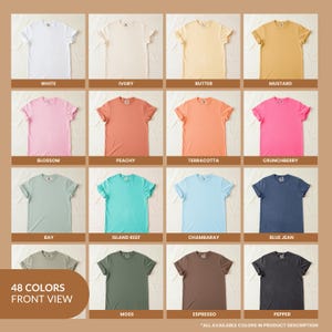 May include: A grid of sixteen short-sleeve crew neck t-shirts displayed in various solid colors including white, ivory, butter, mustard, blossom, peachy, terracotta, crunchberry, bay, island reef, chambaray, blue jean, moss, espresso, and pepper.