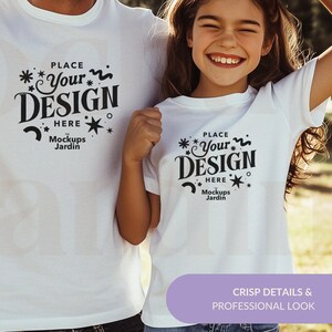 May include: Two white t-shirts with a black design that says "Place Your Design Here" with stars and a wavy line. The text "Mockups Jardin" is below the design.