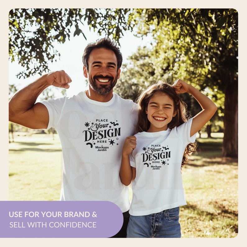 May include: A white t-shirt mockup featuring a father and daughter smiling and flexing their biceps. The shirts have a design that says "Place Your Design Here" with a star and wavy line design. The text "Mockups Jardin" is also included on the shirts.