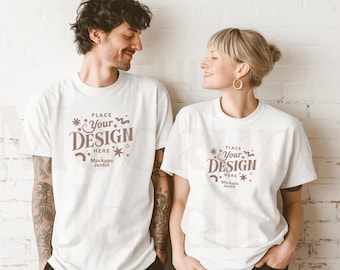 White Comfort Colors 1717 T-Shirt Mockup | Unisex Couple Front View | Tattooed Man Blonde Woman Minimalist Indoor Scene Aesthetic Mockup POD